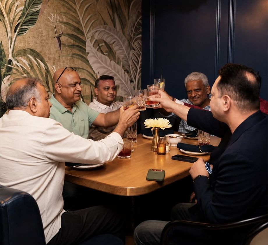 Members raising a toast at a House of Amrut table
